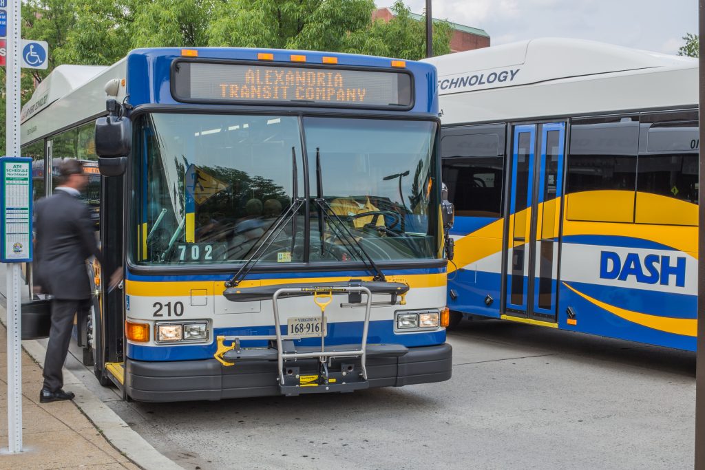 DASH bus picking up passenger with a suit and briefcase.